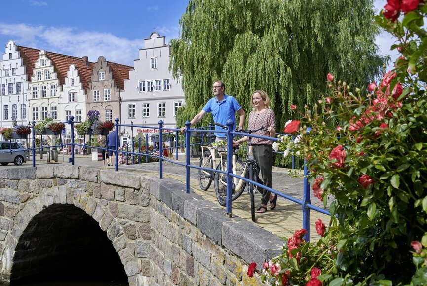 Zwei Personen stehen auf einer Brücke in der Innenstadt